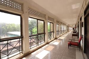 a hallway with windows and benches in a building at Central Hotel in Lucknow