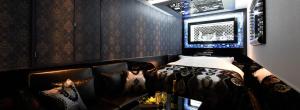 a room with a leather couch with pillows at HOTEL W-PARTY-W GROUP HOTELS and RESORTS- in Kawaguchi