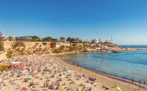 zatłoczona plaża z dużym tłumem ludzi w obiekcie Fantastic Location - Penthouse Duplex in Cabo Roig in walking distance to the beach w mieście Cabo Roig