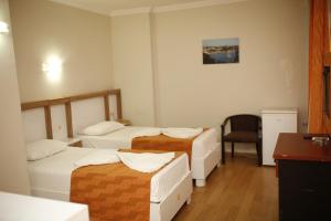 Postel nebo postele na pokoji v ubytování Özhan Hotel