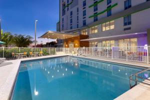 a large swimming pool in front of a building at Wyndham Garden Miami International Airport in Miami