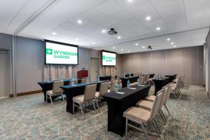 a conference room with tables and chairs and a screen at Wyndham Garden Miami International Airport in Miami +63 photos