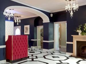 a lobby with blue walls and a red door and a fireplace at Francis Hotel Bath in Bath