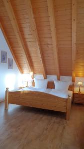 ホイザーンにあるLandgasthof zum Dorfkrugの木製天井の客室の大型ベッド1台分です。