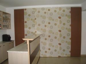 a kitchen with a wall with a pattern of circles at Pansion Ljubica in Međugorje