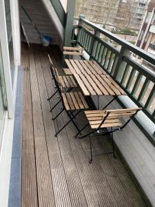 three benches sitting on a balcony with a table and chairs at Appartement 3 Chambres A Koksijde in Koksijde