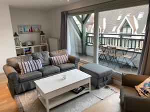 a living room with a couch and a table at Appartement 3 Chambres A Koksijde in Koksijde