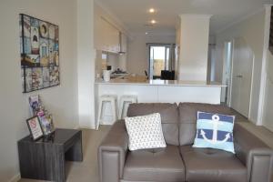 
a living room with a couch and a coffee table at North Coogee Beach House in Fremantle
