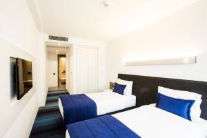 Postel nebo postele na pokoji v ubytování Zeniva Hotel