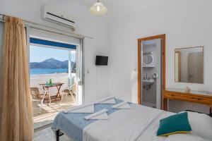 a bedroom with a bed and a view of the ocean at Soulis Studios in Adamantas