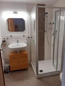 a bathroom with a shower and a sink and a shower at Haus Echtler in Hopferau +29 photos