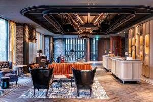a lobby of a hotel with chairs and a table at Just Sleep Tainan in Tainan