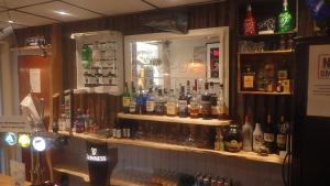 a bar with a lot of bottles of alcohol at The Victoria guest house in Mablethorpe