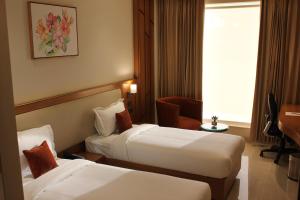 um quarto de hotel com duas camas e uma janela em Anande (The Boutique Hotel) em Sohāna