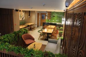 a restaurant with tables and chairs and a dining room at Anande (The Boutique Hotel) in Sohāna