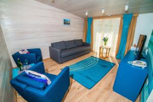 a living room with blue chairs and a couch at Muskatel Boutique Hotel in Gurzuf