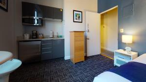 a small kitchen with blue cabinets and a sink at South End Studio, Ideal for Boston Travelers #23 in Boston