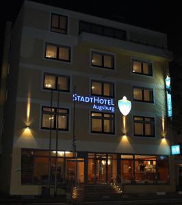 a building with a sign that reads star hotelarchives at Stadthotel Augsburg in Augsburg