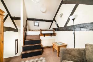 a living room with stairs and a bunk bed at Nant Ucha Farm in Acrefair