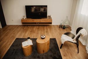 sala de estar con TV, mesa y sillas en Avenue apartment en Slavonski Brod