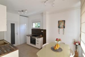 a kitchen with a table with a bowl of bananas on it at Apartment Amelie in Opatija