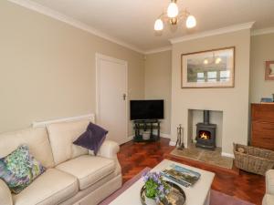 a living room with a couch and a fireplace at Hill View in Darlington