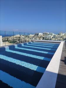a swimming pool with a view of the city at Lure Hotel & Spa - Adults Only in Mellieħa