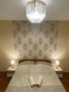 A bed or beds in a room at Virág Vendégház