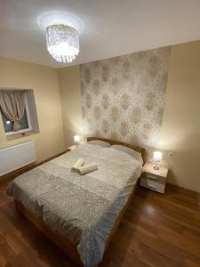 A bed or beds in a room at Virág Vendégház