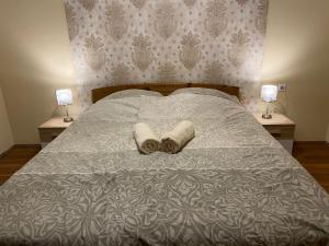 A bed or beds in a room at Virág Vendégház