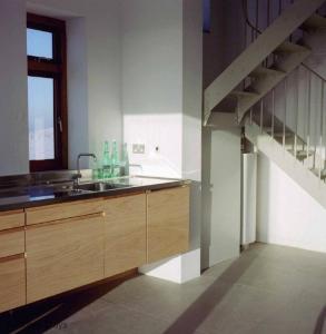 a kitchen with a sink and a staircase at Coastguard Lookout by Bloom Stays in Littlestone-on-Sea