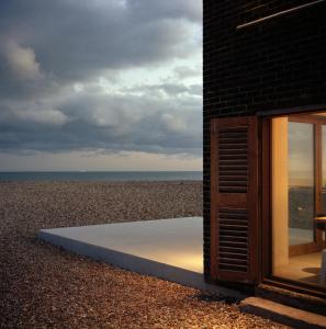a building with a view of the beach at Coastguard Lookout by Bloom Stays in Littlestone-on-Sea
