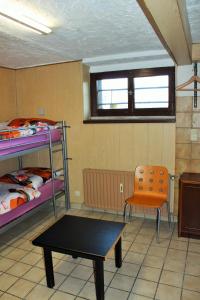 a room with two bunk beds and a table and a chair at Monteur Apartment Victoria in Hagen