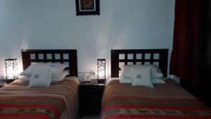 A bed or beds in a room at Cusco Bed and Breakfast