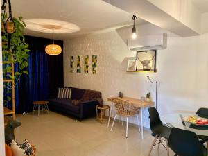 a living room with a couch and a table at Fat Cow Apartment 102 in Livadhia