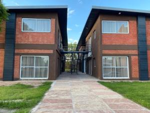 a brick building with a walkway in front of it at COQUENA Departamentos in La Rioja