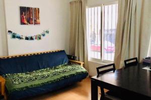 a living room with a couch and a table at Luminoso departamento en el corazón de Olivos in Olivos +13 photos