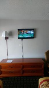 a flat screen tv on the wall of a hotel room at Happy Holiday Motel in Myrtle Beach