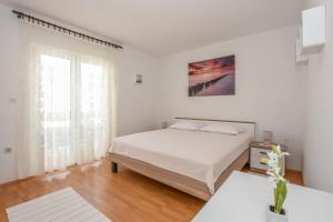 Postel nebo postele na pokoji v ubytování Apartmani Andreja