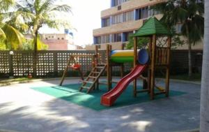a playground with a slide and a play structure at Desarrollo Turístico Punta Brava Tucacas Morrocoy in Tucacas