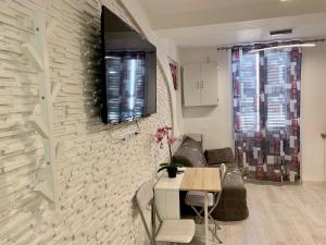 a living room with a table and a wall at Magnifique Studio au cœur historique de Fréjus in Fréjus