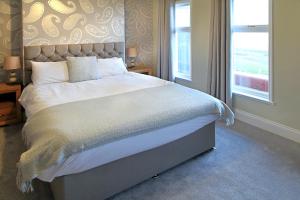 A bed or beds in a room at The Marine Hotel 