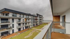 an apartment balcony with a view of the ocean at Apartament 36 Gardenia Seaside - Aprent in Dziwnów