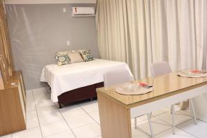 a small room with a bed and a table with chairs at Apartamento pelourinho salvador in Salvador +12 photos