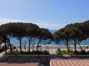 a view of a beach with trees and the ocean at casa Calla in Maiori
