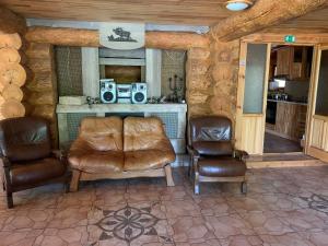 a living room with two chairs and a table with speakers at Rancho Randevu in Koknese