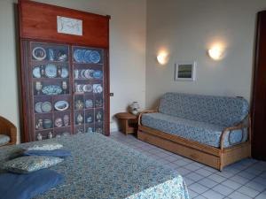 a bedroom with two beds and plates on a wall at casa Calla in Maiori
