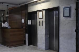 a man standing at a counter in a building at Apartamento pelourinho salvador in Salvador