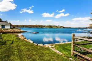 a view of a lake with a fence at Flagship Inn & Suites in Groton