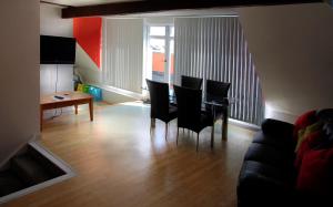 a living room with a dining room table and chairs at Stunning Central Exeter Apartment with balcony and fantastic view in Exeter